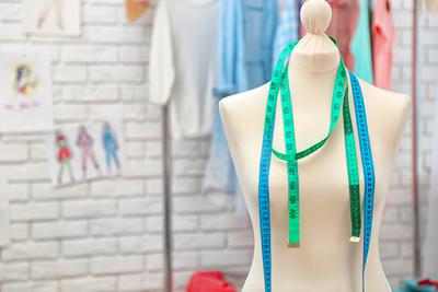 Fashion mannequin with measuring tape around neck.