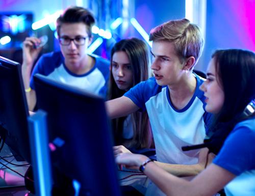 Group of youths around a computer studying
