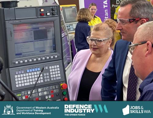 Minister Ellery in a technical workshop with a TAFE lecturer using electronic machinery