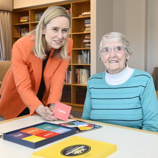 Minister McGuirk with an elderly resident of am aged care home.